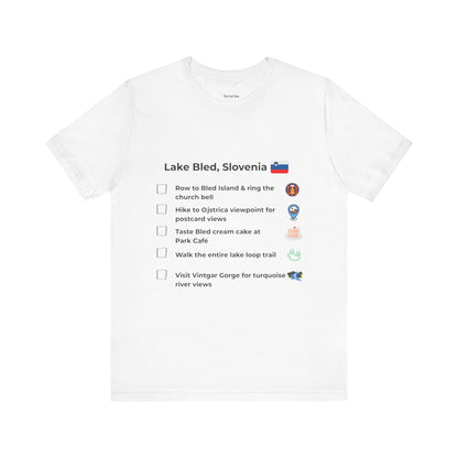 White t-shirt with a checklist of activities related to Lake Bled, Slovenia on a white background.